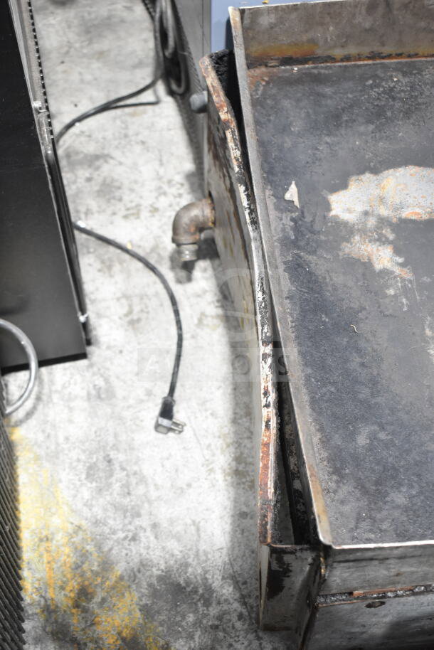 APW Wyott Champion gas countertop griddle with flat top, showing wear and rust, for commercial kitchen use.