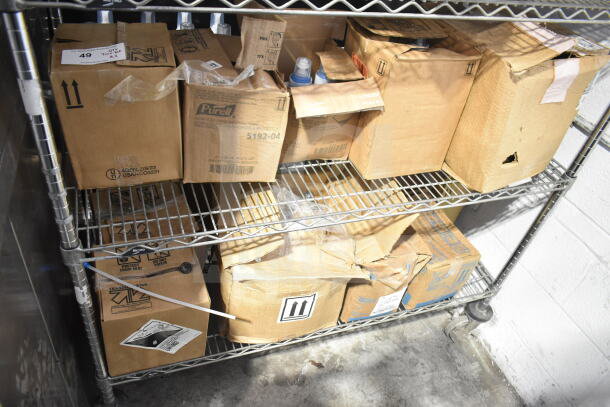 Lot of boxes on metal shelf including Purell Hand Sanitizer cartons, labels visible. Various items, mixed condition.
