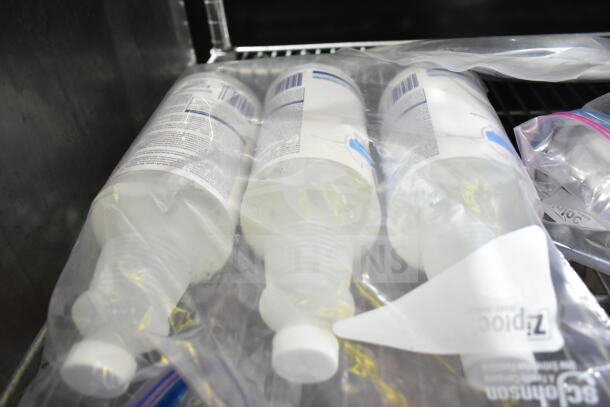 Lot of assorted bottles including Encapsulation Cleanser, dry foam shampoo, and GoJo Hand Cleaner in sealed bags.