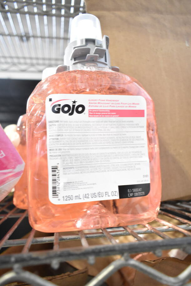 Lot of various items including a GoJo Luxury Foam Handwash, 1250mL, on metal shelf.