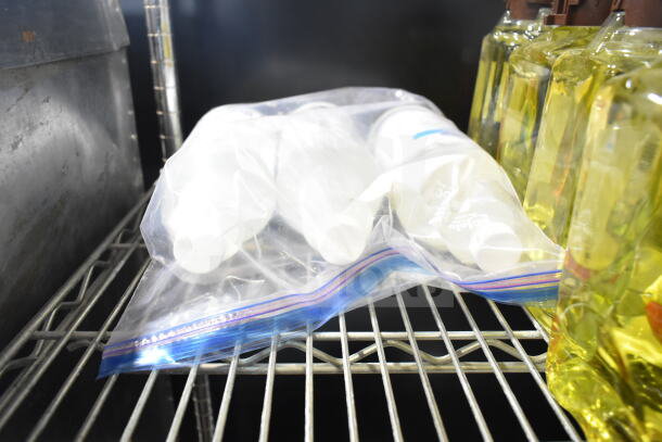 Lot of various items on shelves, including dry foam shampoo, encapsulation cleanser, and GoJo hand cleaner, in plastic bag.