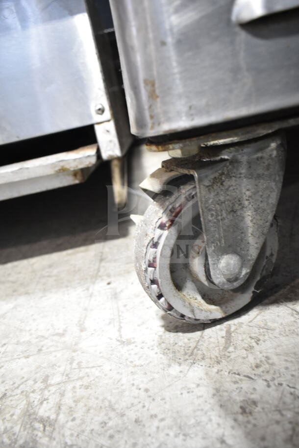 Blodgett oven caster, metal construction, slightly worn, part of commercial convection oven unit.