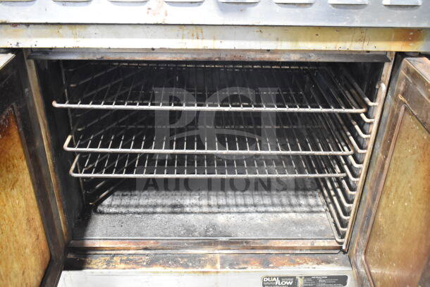 Blodgett commercial convection oven interior with multiple racks. Visible wear, view-through doors, and thermostatic controls.