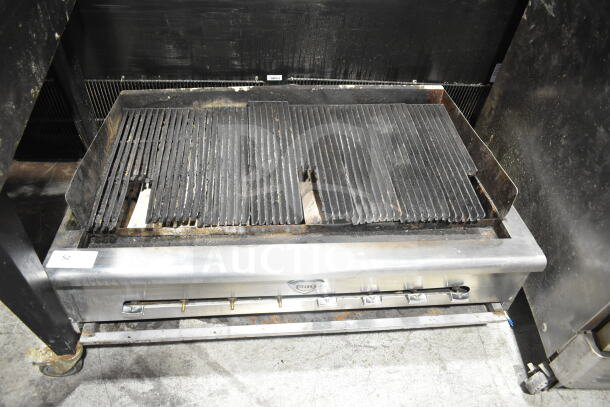 Wells Commercial Gas Charbroiler Grill, countertop model, shows usage wear, stainless steel, visible Wells logo, multiple burners.