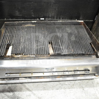 Wells Commercial Gas Charbroiler Grill, countertop model, shows usage wear, stainless steel, visible Wells logo, multiple burners.