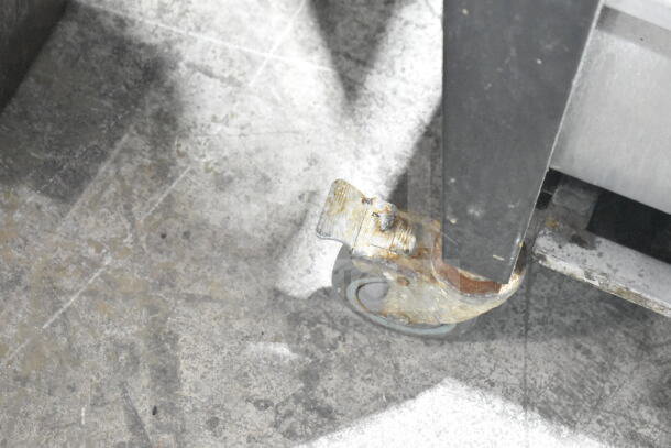 Vulcan Wells convection oven caster, metal legs on commercial casters, showing signs of wear, model VC4GD-11D350K.