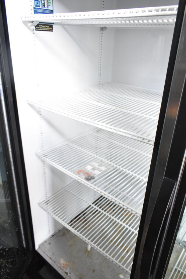 2019 True GDM-72-HC 3 Door Commercial Cooler, 115V, 1 Phase, spacious interior with metal shelves, visible wear.