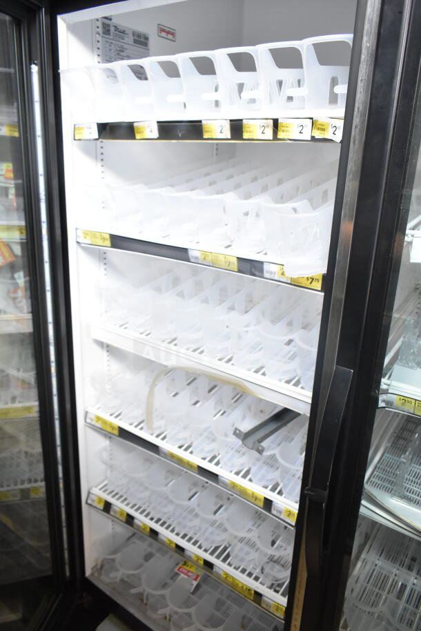 2017 True GDM-72-HC commercial reach-in cooler, 3 doors, 115V, 1-phase. Features empty shelves, visible price tags.
