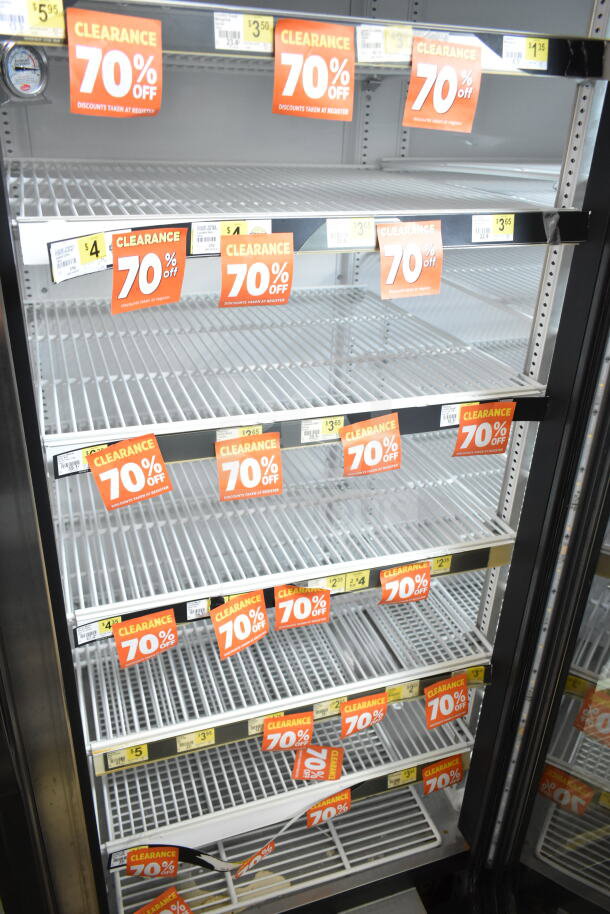 2017 True GDM-72-HC commercial cooler, 3 glass doors, 115 volts, 1 phase, good condition, clearance signage visible.