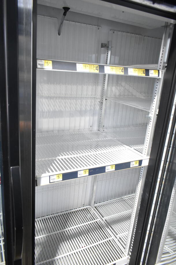 2017 True GDM-72F-HC commercial 3-door reach-in freezer with adjustable shelves, clean interior, black exterior frame.