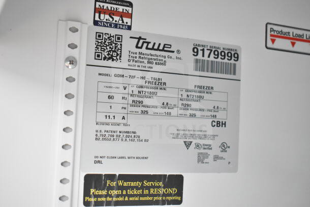 Label on a True GDM-72F-HC freezer, showing model details, voltage, refrigerant info, and barcode. Made in the USA.