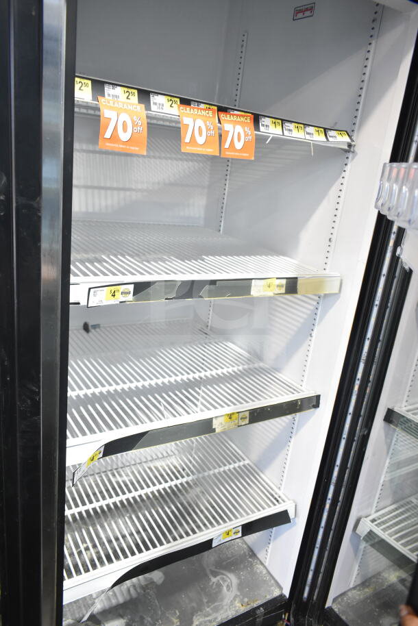 2017 True GDM-72-HC 3 Door Reach In Cooler, 115V, 1 Phase. Features adjustable shelves, visible clearance signage.