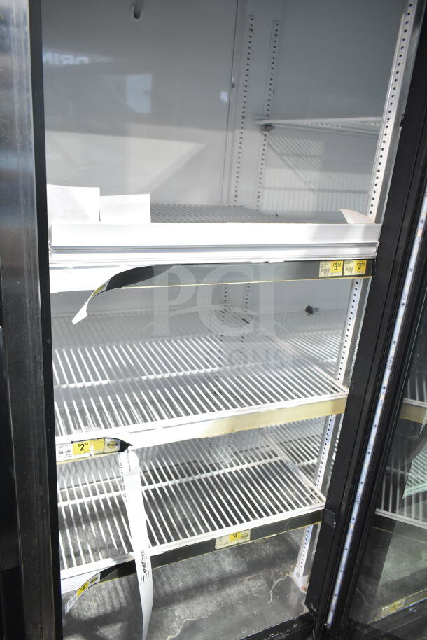 2017 True GDM-72-HC commercial 3-door cooler merchandiser with glass doors, interior shelving, and visible price tags. 115 Volts, 1 Phase.