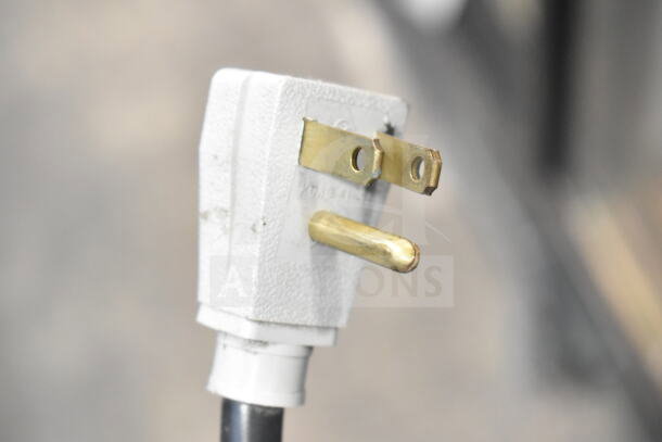 Close-up of a three-prong electrical plug for a 2017 True GDM-72-HC commercial cooler, model details not visible.