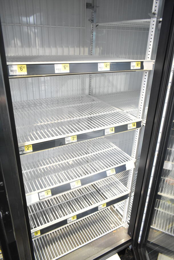 2017 True GDM-72F-HC Commercial 3 Door Reach In Freezer, empty shelves, price tags visible. 115/208-230 Volts, 1 Phase.