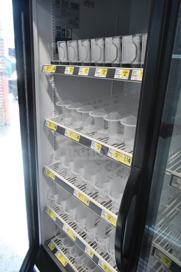 2019 True GDM-49-HC commercial cooler, 2 glass doors, internal shelving, 115V, excellent condition, price tags visible.