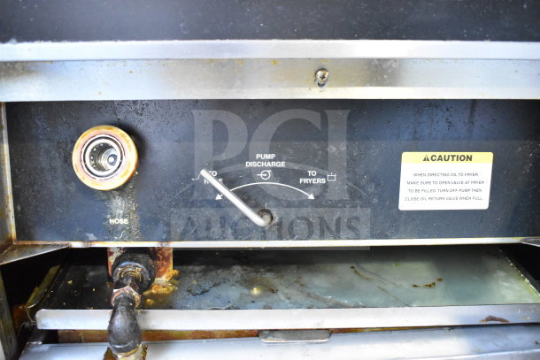 Giles EOF-24 commercial fryer with dumping station. Features pump discharge controls, caution label, and visible wear.