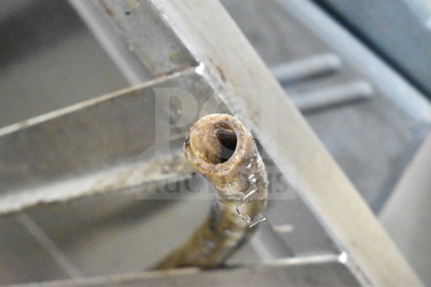 Pipe detail of Vulcan C24EO3 steam cabinet. Focus on rust and wear, highlighting condition for maintenance needs.