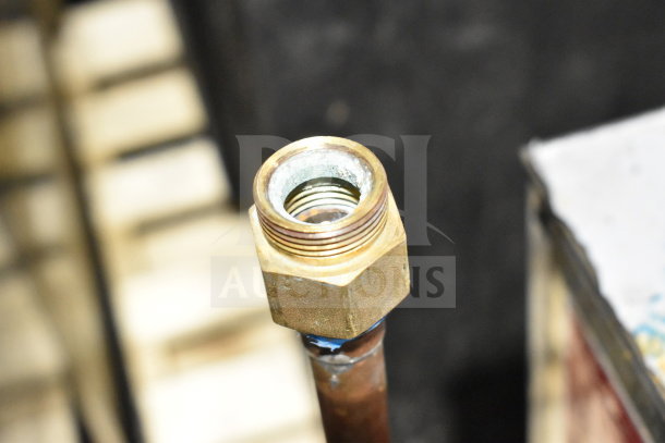 Close-up of a brass fitting on a metal pipe. Details for Noble Wareforce UL30 dishwasher not visible.