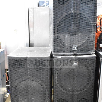 Three Electro Voice EV TX1181 subwoofers, direct radiating design, black casing, sturdy condition, EV branding on front grille.