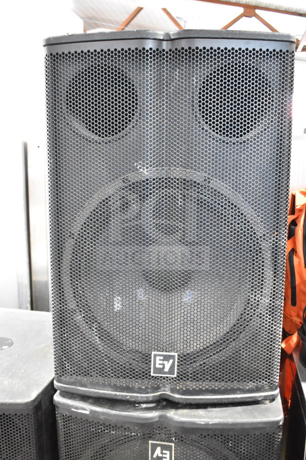 Electro Voice EV TX1181 subwoofer speaker with protective grille, sturdy cabinet, and EV logo. Auction includes three units.