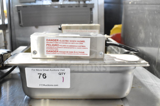 Birmingham 815234X2 evaporator condensate pan, 208 volts, features electric shock hazard warning label, auction ID tag visible.