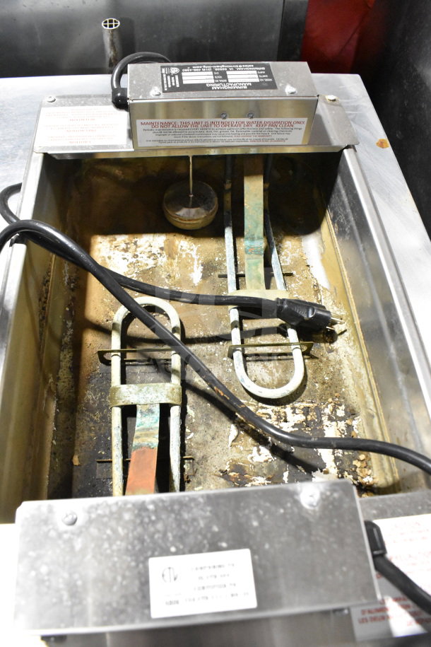 Birmingham 815234X2 evaporator condensate pan, 208 volts, shows wear and corrosion, visible labels indicating model and warnings.