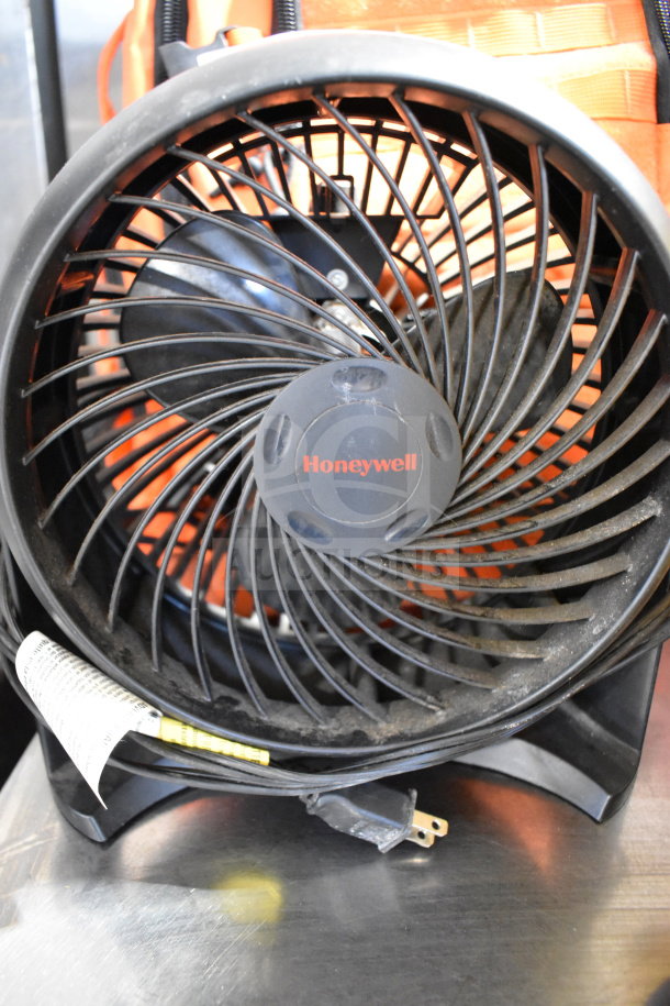 5 assorted items: Honeywell HT-900 fan, CFM-222A blower, Fox Tactical orange backpack, 20 lb ball. Some signs of wear.