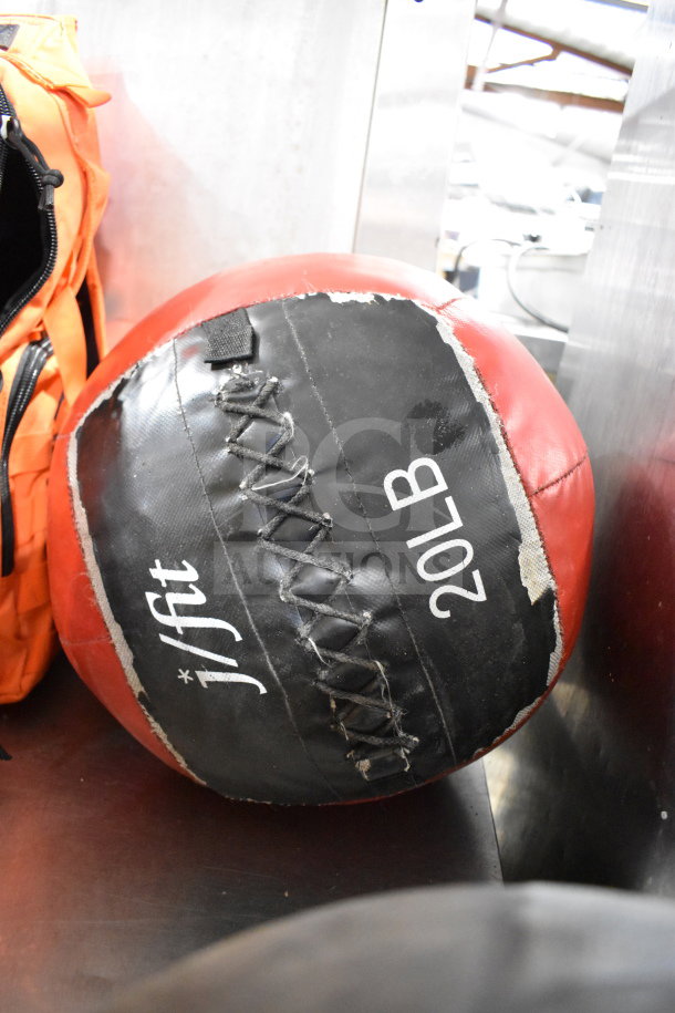 20 lb j/fit ball with visible wear and stitching, next to Fox Tactical orange backpack.