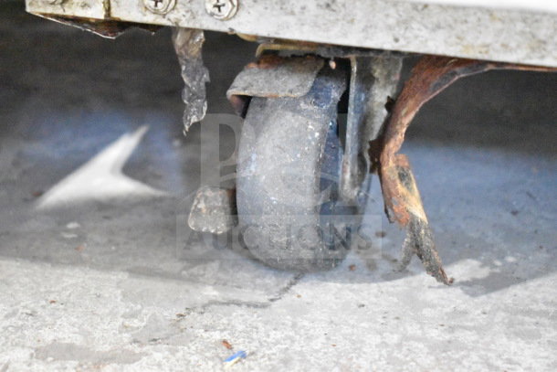 Turbo Air M3F19-1 freezer's worn caster wheel with visible rust, indicating wear and mobility condition issues.