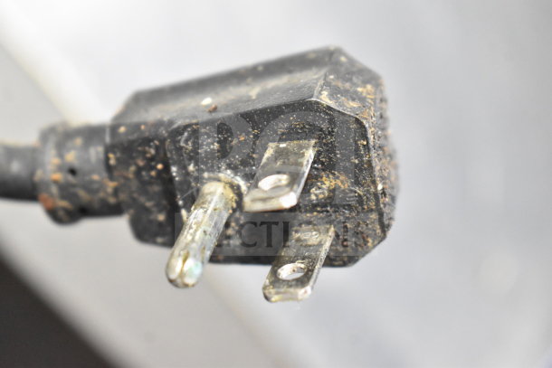 Close-up of a worn electrical plug on a Turbo Air MST-48-N commercial sandwich salad prep table.