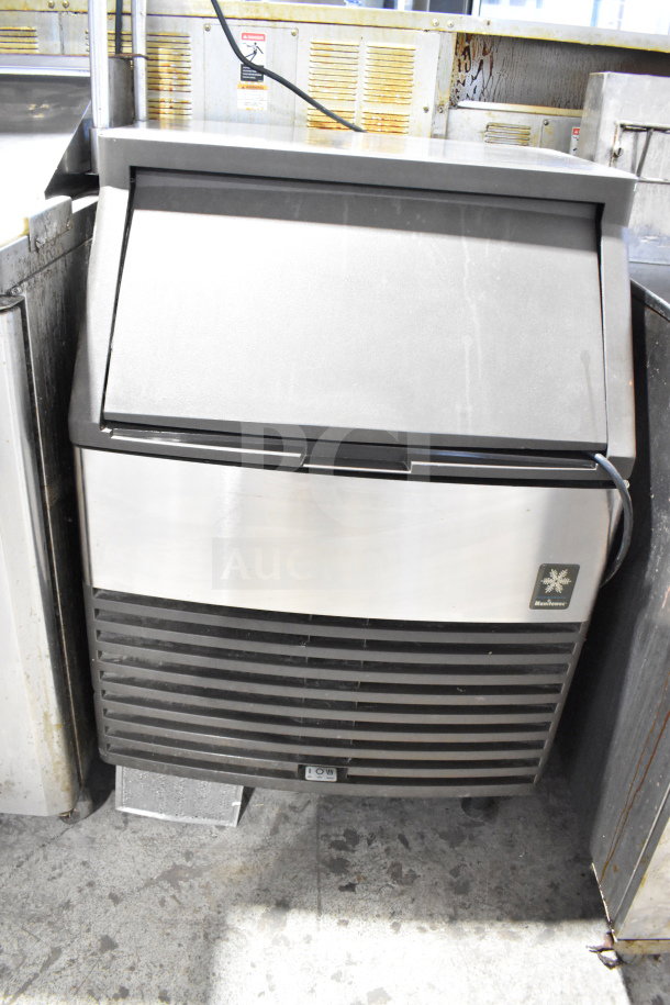 Manitowoc QD0212A commercial undercounter ice machine, 115V, self-contained, black and silver, visible logo, good condition.