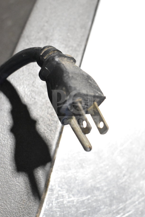 Power plug of Manitowoc QD0212A Ice Machine, 115V, 1 Phase; visible wear, black cable.