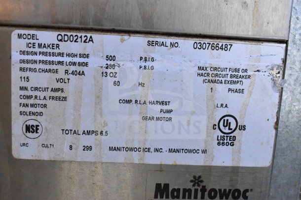 Manitowoc QD0212A ice machine label detail showing specs: 115 volts, refrigerant R-404A, UL listed, serial no. 030766487.