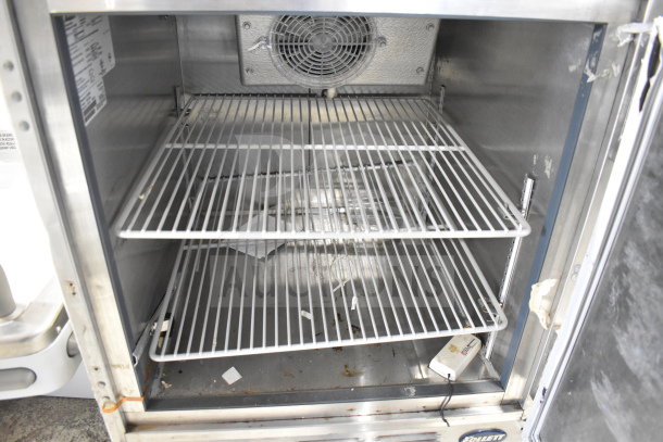 Follett REF5 commercial undercounter cooler, single door, 115 volts, visible shelving, used condition, interior view.
