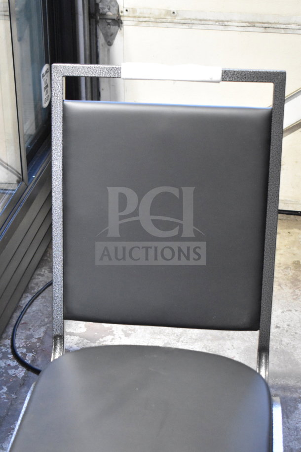 Brand new Lancaster Table & Seating square back banquet chair with black vinyl, silver vein frame. Scratch and dent condition.