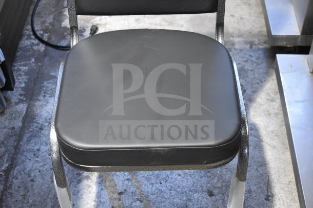 16 brand new Lancaster Table & Seating banquet chairs, black vinyl, silver vein frame, scratch and dent condition.