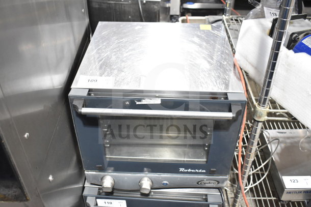 2023 Cadco Unox XAF003-US Roberta countertop convection oven, electric-powered, stainless steel, 120V, with visible control knobs.
