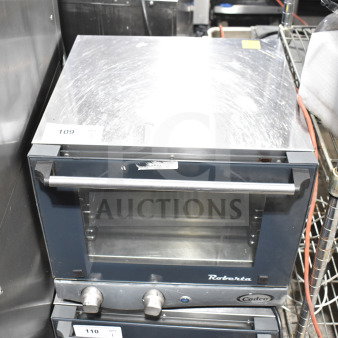 2023 Cadco Unox XAF003-US Roberta countertop convection oven, electric-powered, stainless steel, 120V, with visible control knobs.