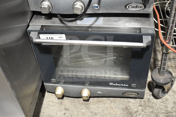 Cadco Unox XAF003 Roberta convection oven, metal, 120V, 1 phase, countertop model, used, visible dials and branding.