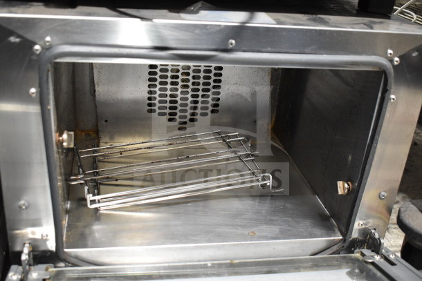 Cadco Unox XAF003 Roberta convection oven, metal, countertop, electric, 120V, 1 phase. Interior view, clean condition.