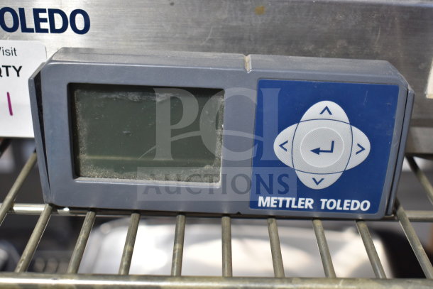 Mettler Toledo BC commercial countertop food portioning scale with digital display, slight wear visible on the screen.
