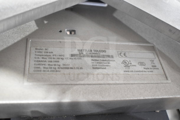 Mettler Toledo BC commercial food portioning scale plate, showing model and certification label for max 150 lb/60 kg capacity.