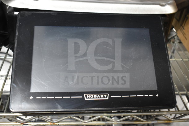 Hobart commercial countertop food portioning scale, black finish, touchscreen interface, model label visible.