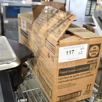Two boxes of Kay food grade lubricant on a metal shelf. Label indicates auction lot number 117, quantity 2.