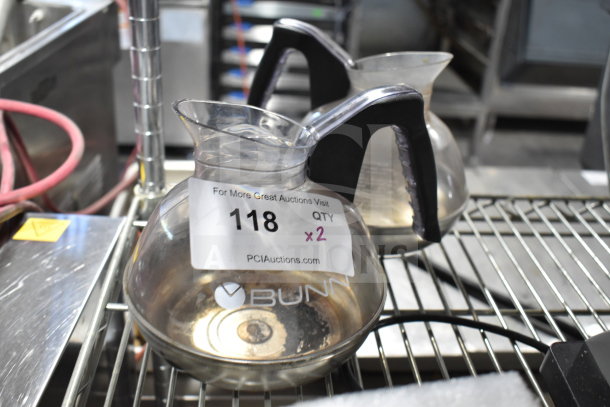 Bunn coffee pots, two units, transparent with black handles, marked "118 QTY x2" for auction.