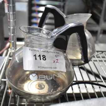 Bunn coffee pots, two units, transparent with black handles, marked "118 QTY x2" for auction.