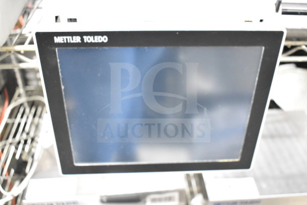 Mettler Toledo countertop food portioning scale, digital display, used condition, visible brand label.