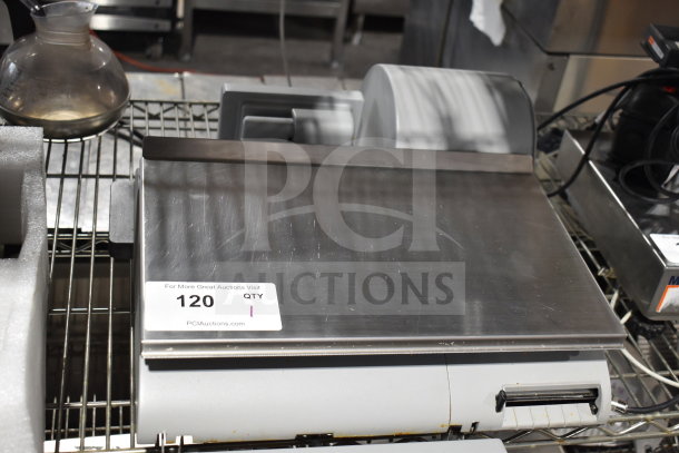 Mettler Toledo countertop food portioning scale with metal platform. Used condition. Auction tag reads: "120 QTY 1".