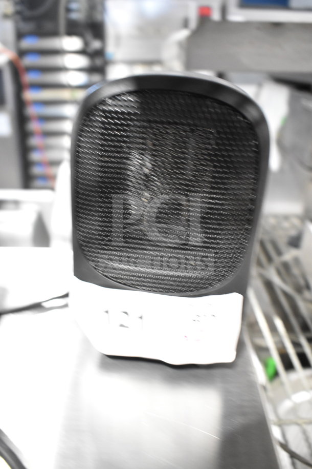 Mainstays MH-16B ceramic heater, black, in good condition. Mesh front, white base with visible label. Aquiline pedal not shown.